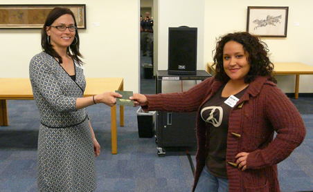 Outreach Librarian Anne Switzer presents first prize award to Melissa Rios